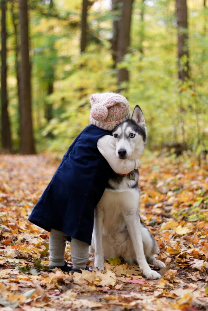 Photo of a child hugging a dog